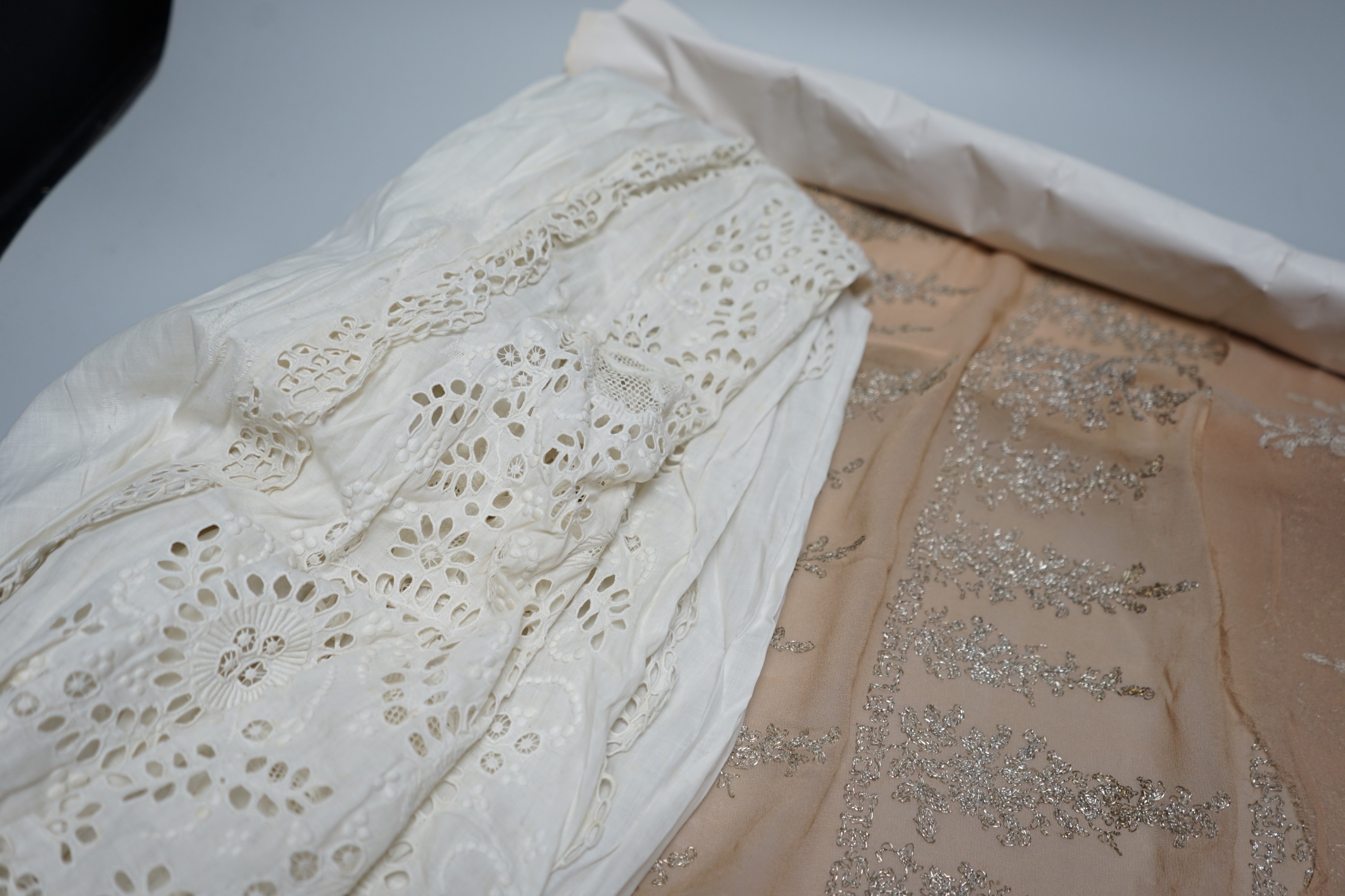 A long length of 1930’s silver lace trimming a similar panel, chiffon and silver embroidered fabric, an ornate 19th century cut worked christening gown etc